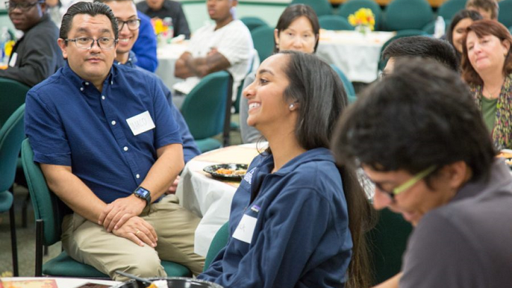 Students and faculty interact at luncheon.